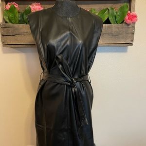 Faux leather mini dress by Bohme. Shoulder pad accents and belted waist.